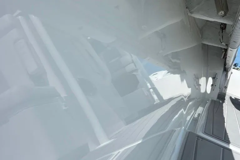  Yacht Photos Pics 2023 Contender 39 ST boat, sleek white exterior with reflective surface.
