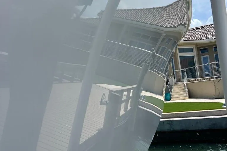  Yacht Photos Pics Reflection of a house on the hull of a 2023 Contender 39 ST boat.