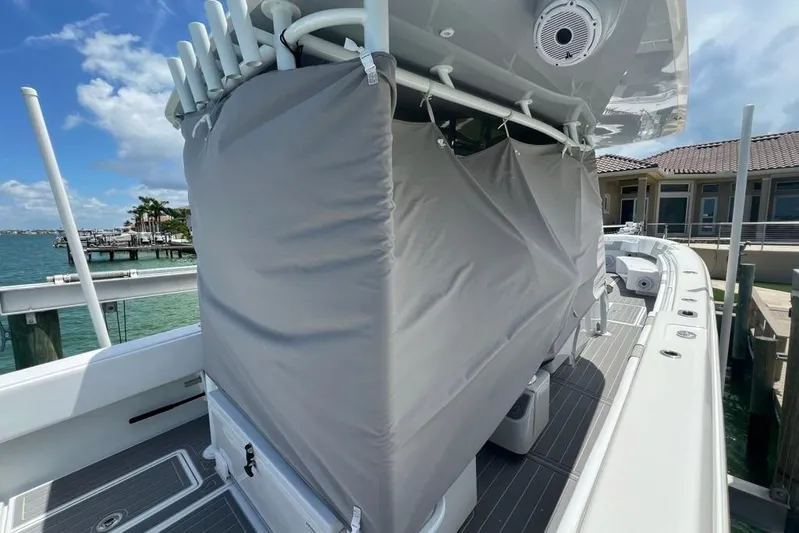  Yacht Photos Pics 2023 Contender 39 ST boat with covered console, docked by waterfront homes.