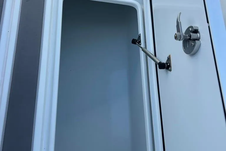  Yacht Photos Pics Open storage compartment on 2023 Contender 39 ST boat, featuring secure latch mechanism.