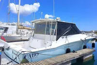 2011 Cabo Express 40 boat docked at marina under clear blue sky.