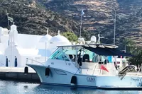 2011 Cabo Express 40 yacht docked near white buildings and scenic hills.