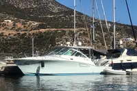 2011 Cabo Express 40 yacht docked in scenic marina with mountainous backdrop.