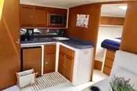 Interior of 2011 Cabo Express 40 yacht with kitchenette and cozy sleeping area.
