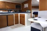 Interior of 2011 Cabo Express 40 yacht with kitchenette and seating area.