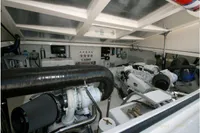 Engine room of 2011 Cabo Express 40 boat, showcasing dual engines and mechanical components.