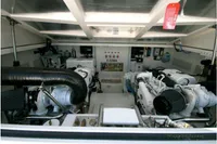 Engine room of 2011 Cabo Express 40 boat, showcasing dual engines and mechanical components.