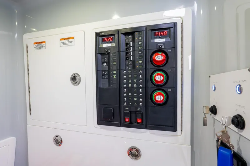  Yacht Photos Pics Electrical panel of 2023 Valhalla Boatworks V-33, featuring control switches and digital displays.