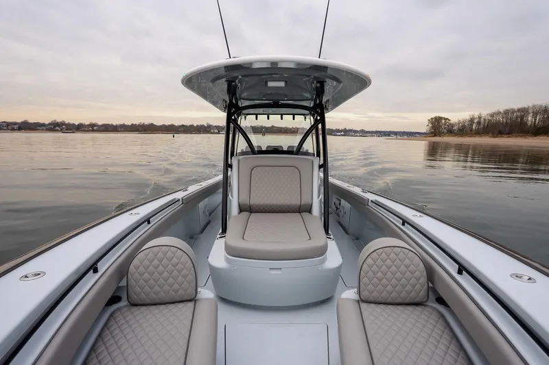  Yacht Photos Pics 2023 Valhalla Boatworks V-33 on calm water, featuring luxurious seating and sleek design.