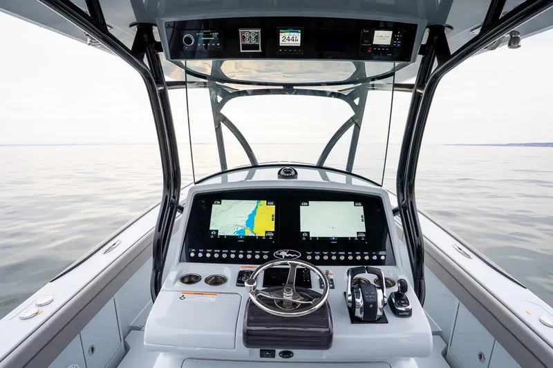  Yacht Photos Pics 2023 Valhalla Boatworks V-33 helm with advanced navigation displays on calm water.
