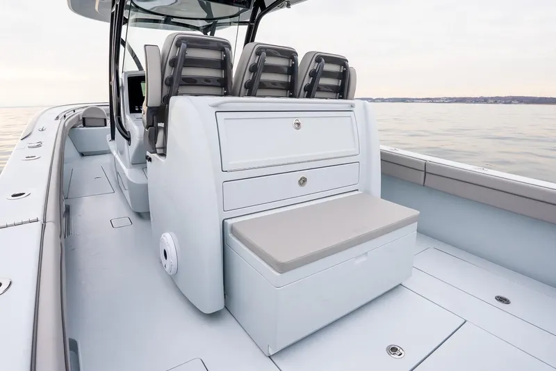  Yacht Photos Pics 2023 Valhalla Boatworks V-33 interior with seating and storage on calm water.