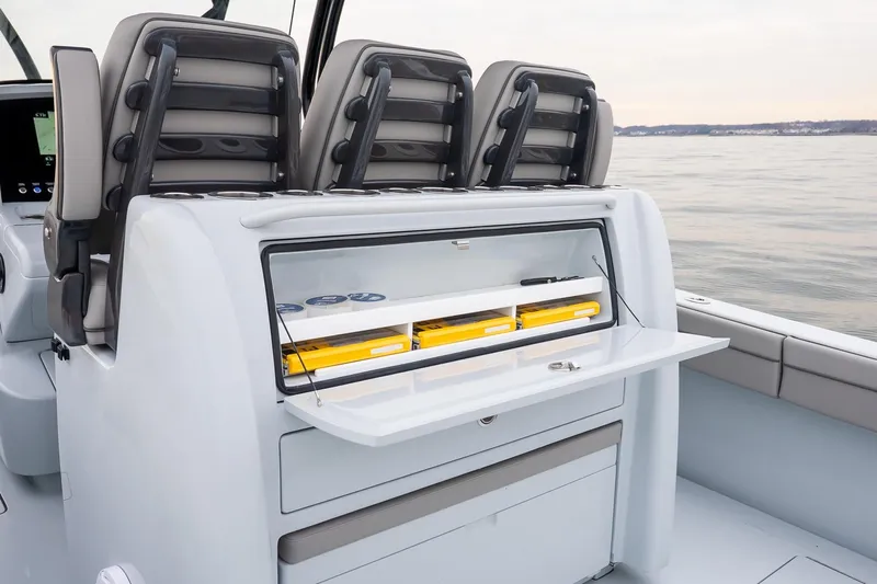  Yacht Photos Pics 2023 Valhalla Boatworks V-33 interior with storage compartment and seating on calm water.