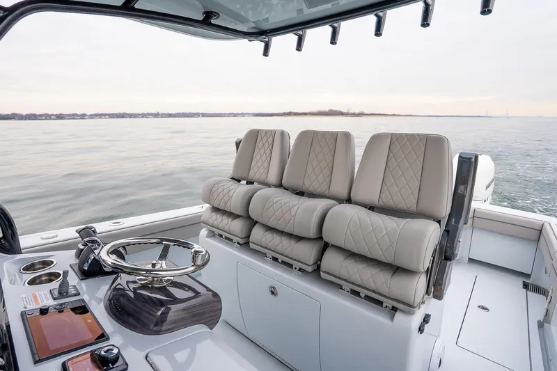  Yacht Photos Pics 2023 Valhalla Boatworks V-33 interior with luxurious seating and modern helm controls.