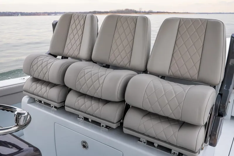  Yacht Photos Pics 2023 Valhalla Boatworks V-33 luxury seating with diamond-stitched upholstery on calm waters.