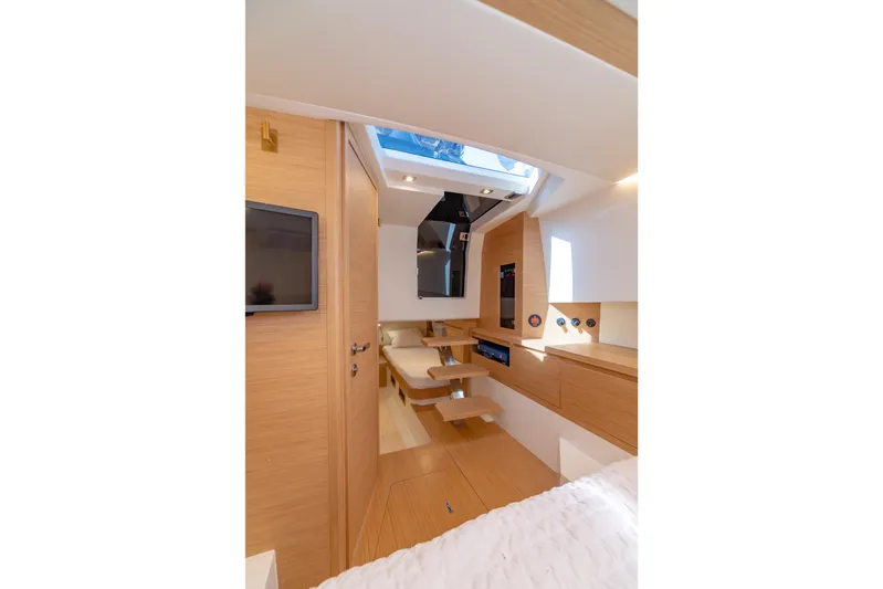 Scouser Yacht Photos Pics Luxurious interior of 2025 Pardo Yachts P38R, featuring modern wood finishes and skylight.
