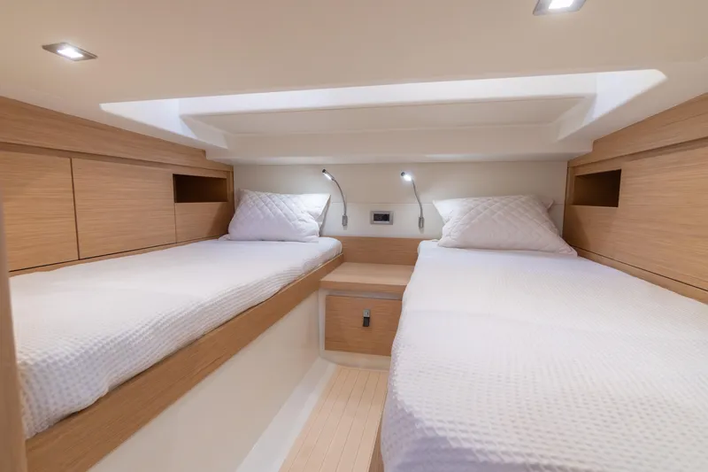 Scouser Yacht Photos Pics 2025 Pardo Yachts P38R cabin with twin beds, modern wood finish, and ambient lighting.
