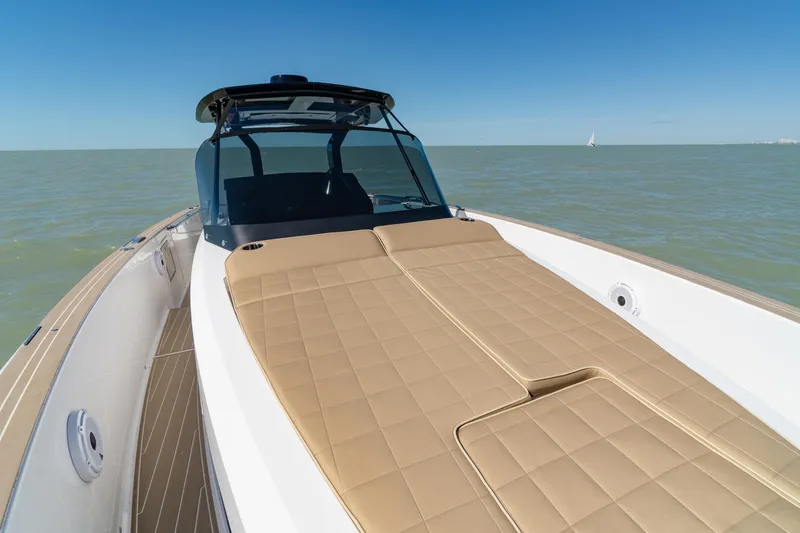 Scouser Yacht Photos Pics 2025 Pardo Yachts P38R luxury yacht with tan sunbed, cruising on calm waters.