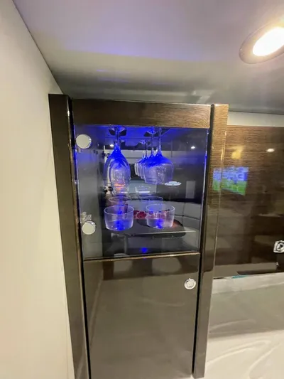 Nauti Dog II Yacht Photos Pics Modern glass cabinet with blue LED lighting in a 2021 Formula 40 PC yacht.