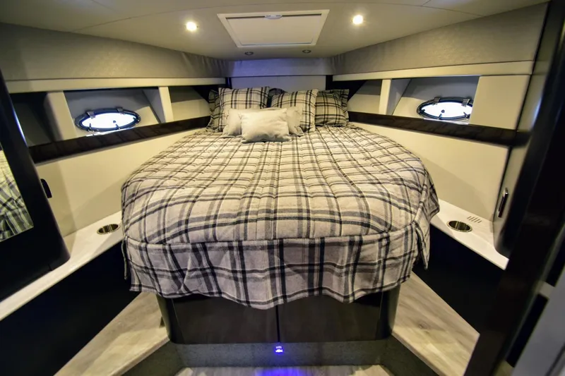 Nauti Dog II Yacht Photos Pics Cozy bedroom in 2021 Formula 40 PC yacht with plaid bedding and ambient lighting.