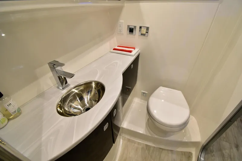 Nauti Dog II Yacht Photos Pics Modern bathroom in 2021 Formula 40 PC yacht with sleek sink and toilet.