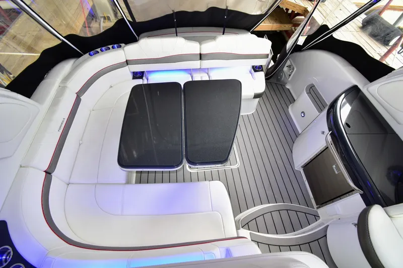 Nauti Dog II Yacht Photos Pics 2021 Formula 40 PC yacht interior with white seating and modern design.