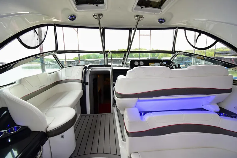 Nauti Dog II Yacht Photos Pics 2021 Formula 40 PC yacht interior with white seating and modern dashboard.