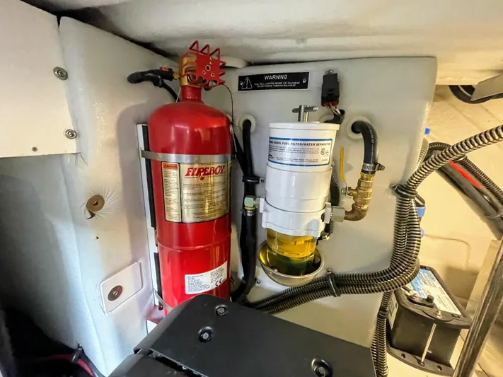 Nauti Dog II Yacht Photos Pics Engine compartment of a 2021 Formula 40 PC with fire extinguisher and fuel filter.