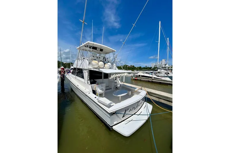  Yacht Photos Pics 1990 Viking 48 Convertible yacht docked at marina under clear blue sky.