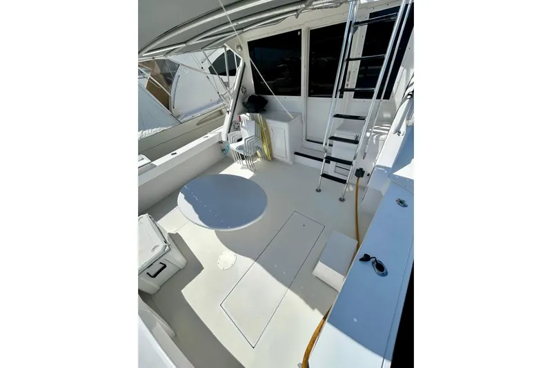  Yacht Photos Pics 1990 Viking 48 Convertible yacht deck with seating and ladder.