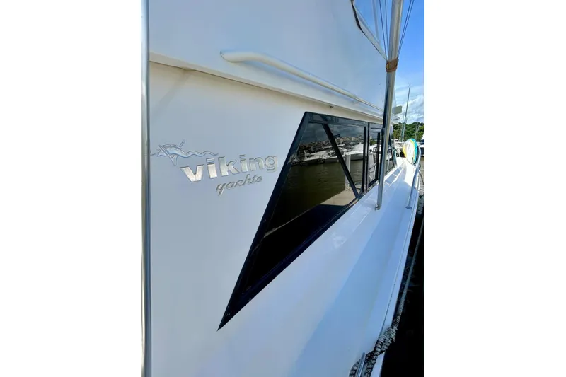  Yacht Photos Pics 1990 Viking 48 Convertible yacht side view with logo, docked at marina.