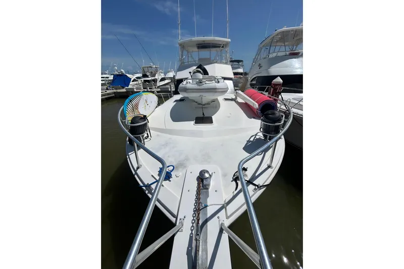  Yacht Photos Pics 1990 Viking 48 Convertible yacht docked at marina, featuring spacious deck and fishing gear.
