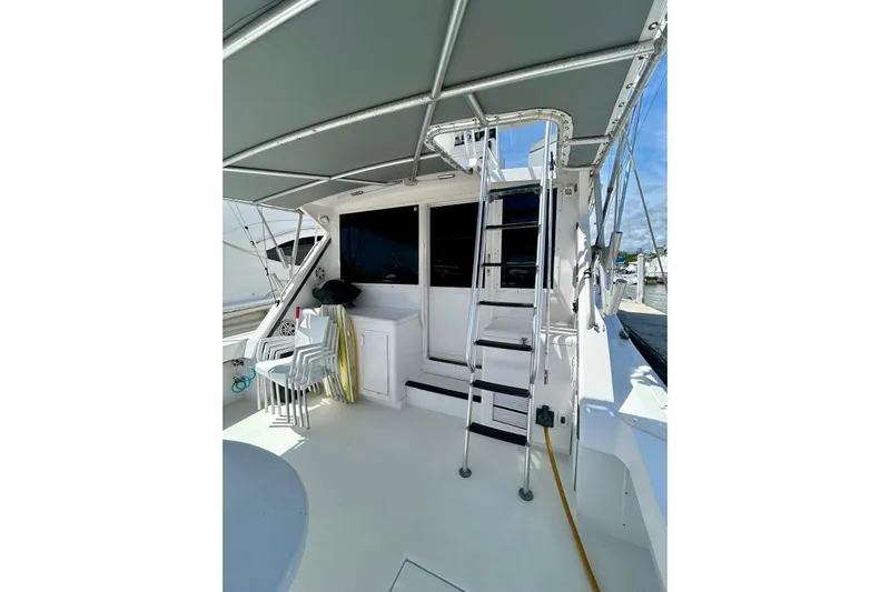  Yacht Photos Pics 1990 Viking 48 Convertible yacht deck with ladder and seating area.