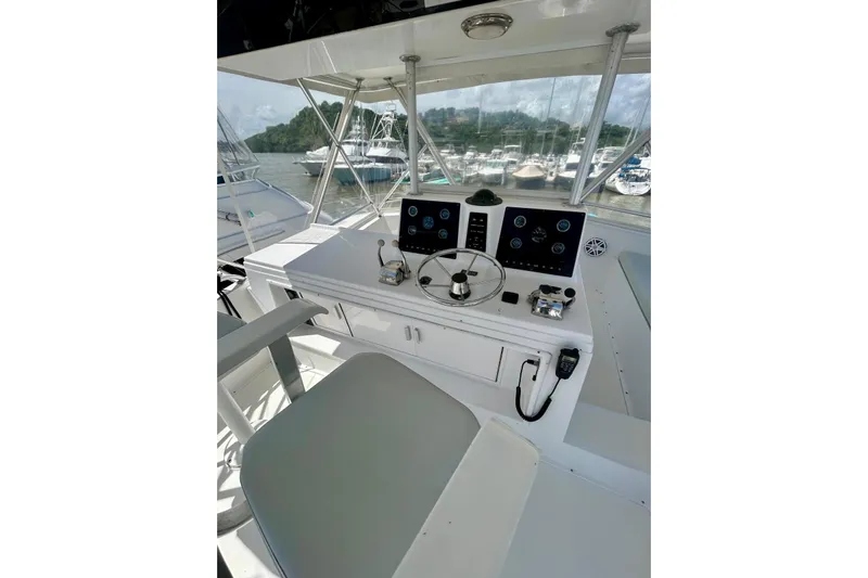  Yacht Photos Pics 1990 Viking 48 Convertible yacht helm with steering wheel and control panel.