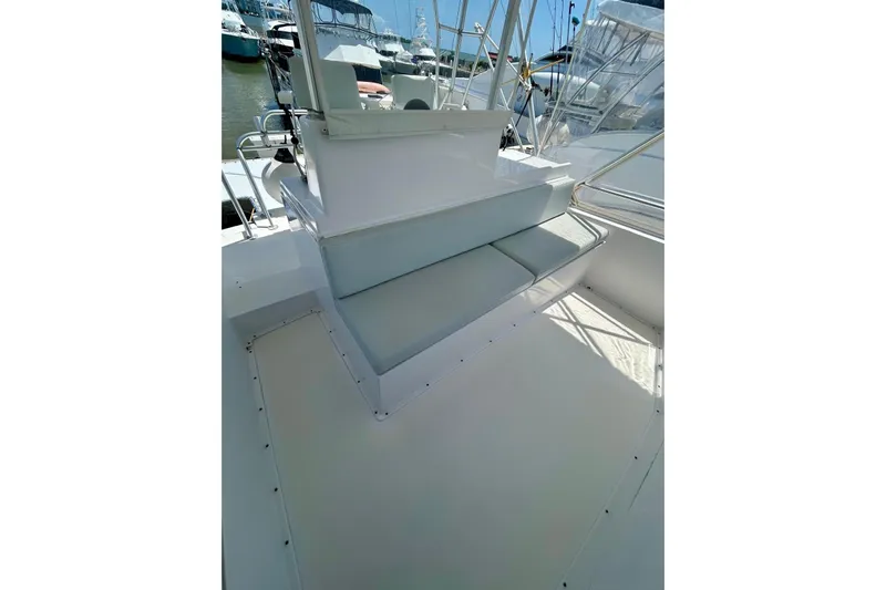  Yacht Photos Pics 1990 Viking 48 Convertible yacht deck with seating, docked in marina.