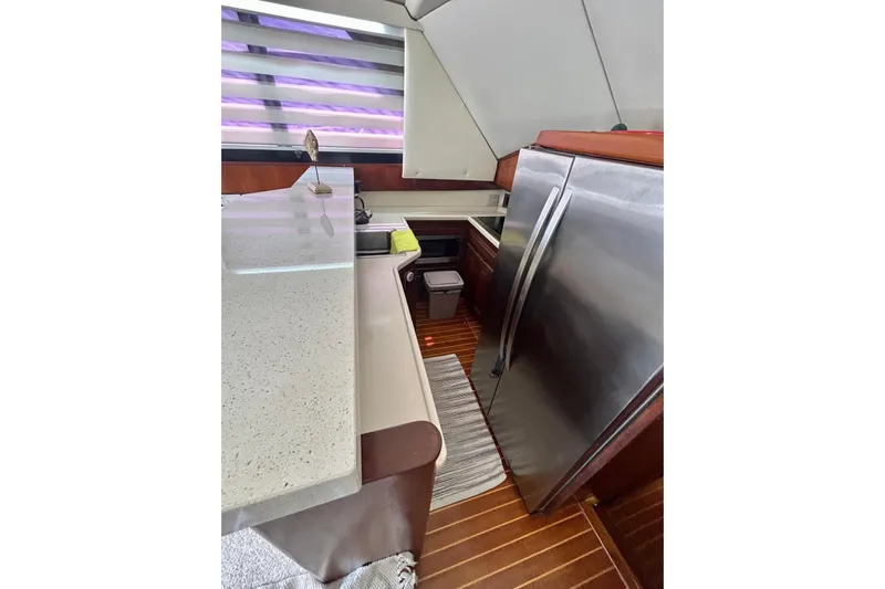  Yacht Photos Pics 1990 Viking 48 Convertible yacht kitchen with modern appliances and sleek countertops.