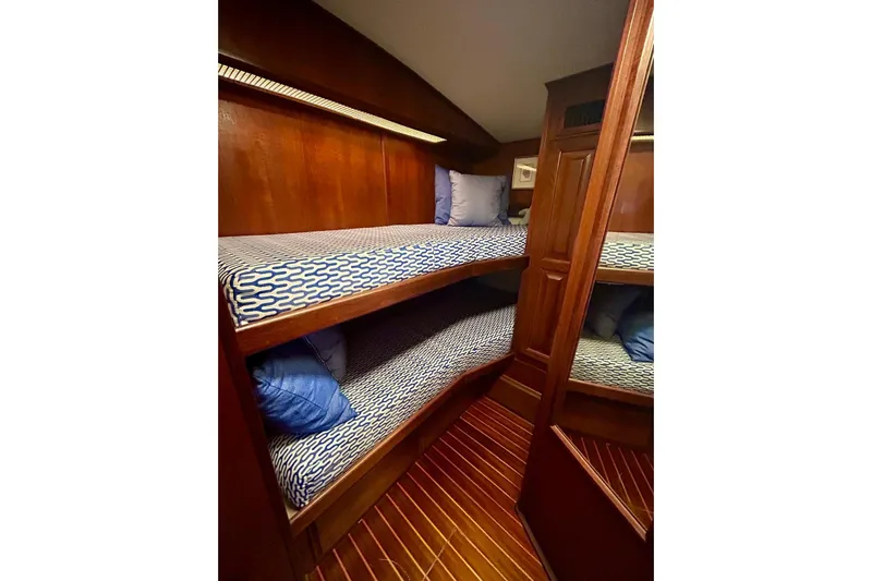  Yacht Photos Pics 1990 Viking 48 Convertible yacht interior with wooden bunk beds and blue patterned bedding.