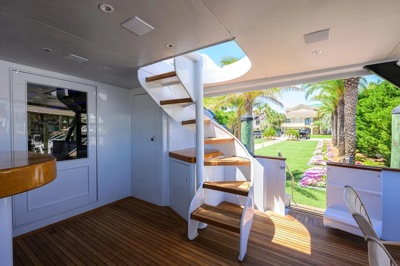  Yacht Photos Pics Interior of 1997 Broward 108 Raised Pilothouse yacht with wooden stairs and deck.