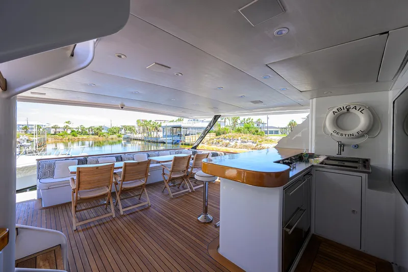 Yacht Photos Pics Spacious deck of 1997 Broward 108 Raised Pilothouse yacht with outdoor seating and bar area.
