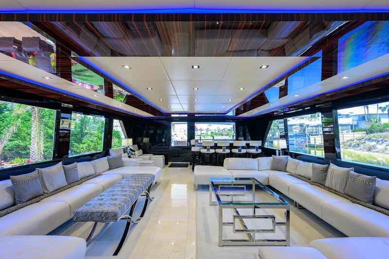  Yacht Photos Pics Luxurious interior of 1997 Broward 108 Raised Pilothouse yacht with modern seating and glass tables.