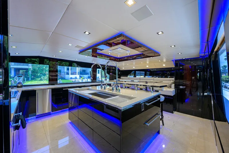  Yacht Photos Pics Luxurious kitchen interior of 1997 Broward 108 Raised Pilothouse yacht with modern lighting.