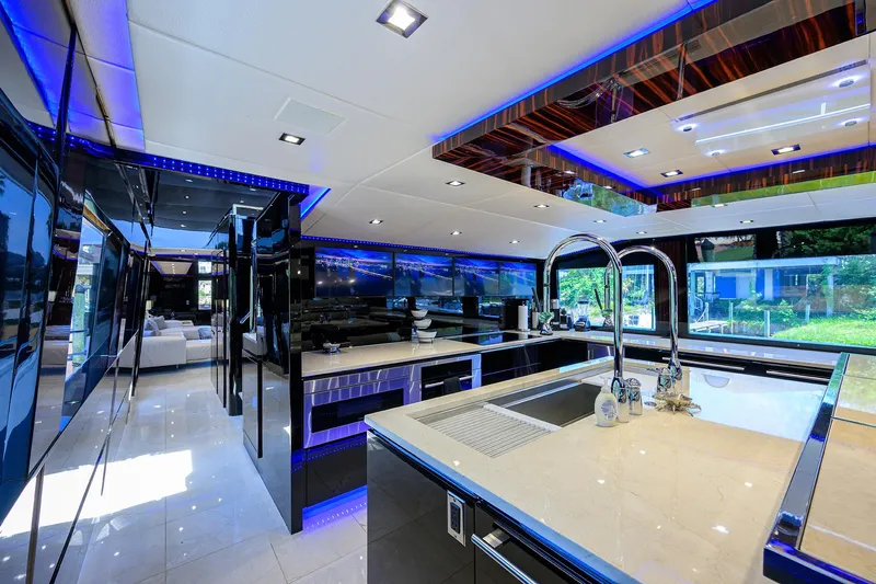  Yacht Photos Pics Luxurious kitchen interior of 1997 Broward 108 Raised Pilothouse yacht with modern fixtures.