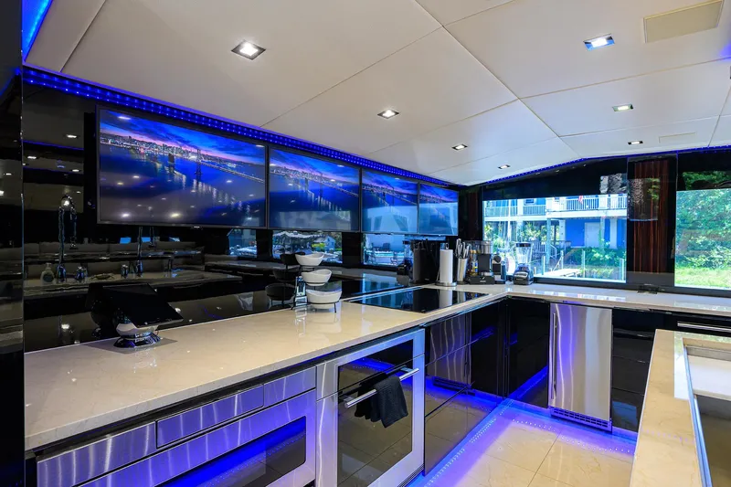  Yacht Photos Pics Luxurious kitchen interior of 1997 Broward 108 Raised Pilothouse yacht with modern appliances and blue LED lighting.