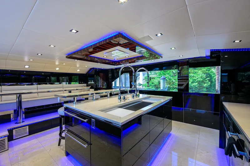  Yacht Photos Pics Luxurious kitchen interior of 1997 Broward 108 Raised Pilothouse yacht with modern fixtures.