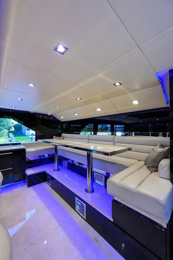  Yacht Photos Pics Luxurious interior of 1997 Broward 108 Raised Pilothouse yacht with modern seating and blue LED lighting.