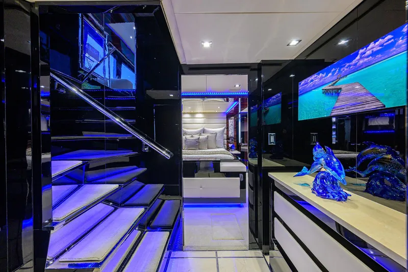 Yacht Photos Pics Luxurious interior of 1997 Broward 108 Raised Pilothouse yacht with modern decor and blue lighting.