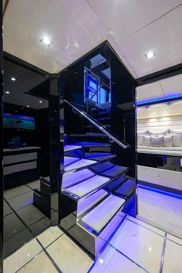  Yacht Photos Pics Luxurious interior of 1997 Broward 108 Raised Pilothouse yacht with modern staircase and blue LED lighting.