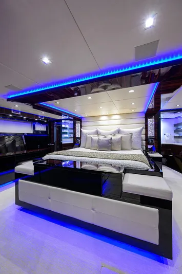  Yacht Photos Pics Luxurious bedroom interior of 1997 Broward 108 Raised Pilothouse yacht with modern lighting.