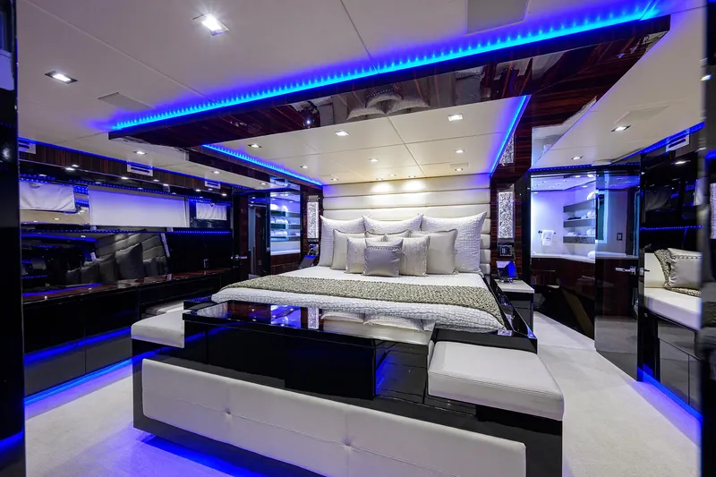  Yacht Photos Pics Luxurious bedroom interior of 1997 Broward 108 Raised Pilothouse yacht with blue LED lighting.