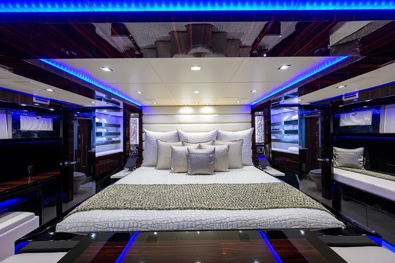  Yacht Photos Pics Luxurious bedroom interior of 1997 Broward 108 Raised Pilothouse yacht with blue LED lighting.