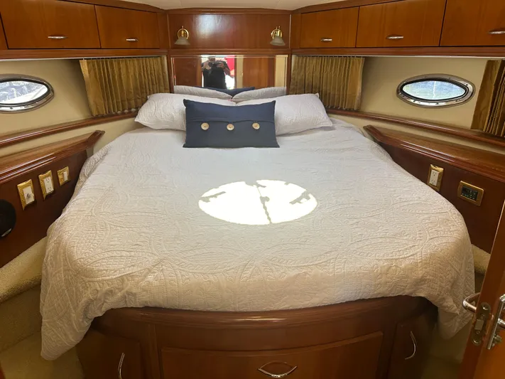  Yacht Photos Pics Luxurious bedroom interior of 2004 Carver 420 Mariner yacht with elegant wood finish.